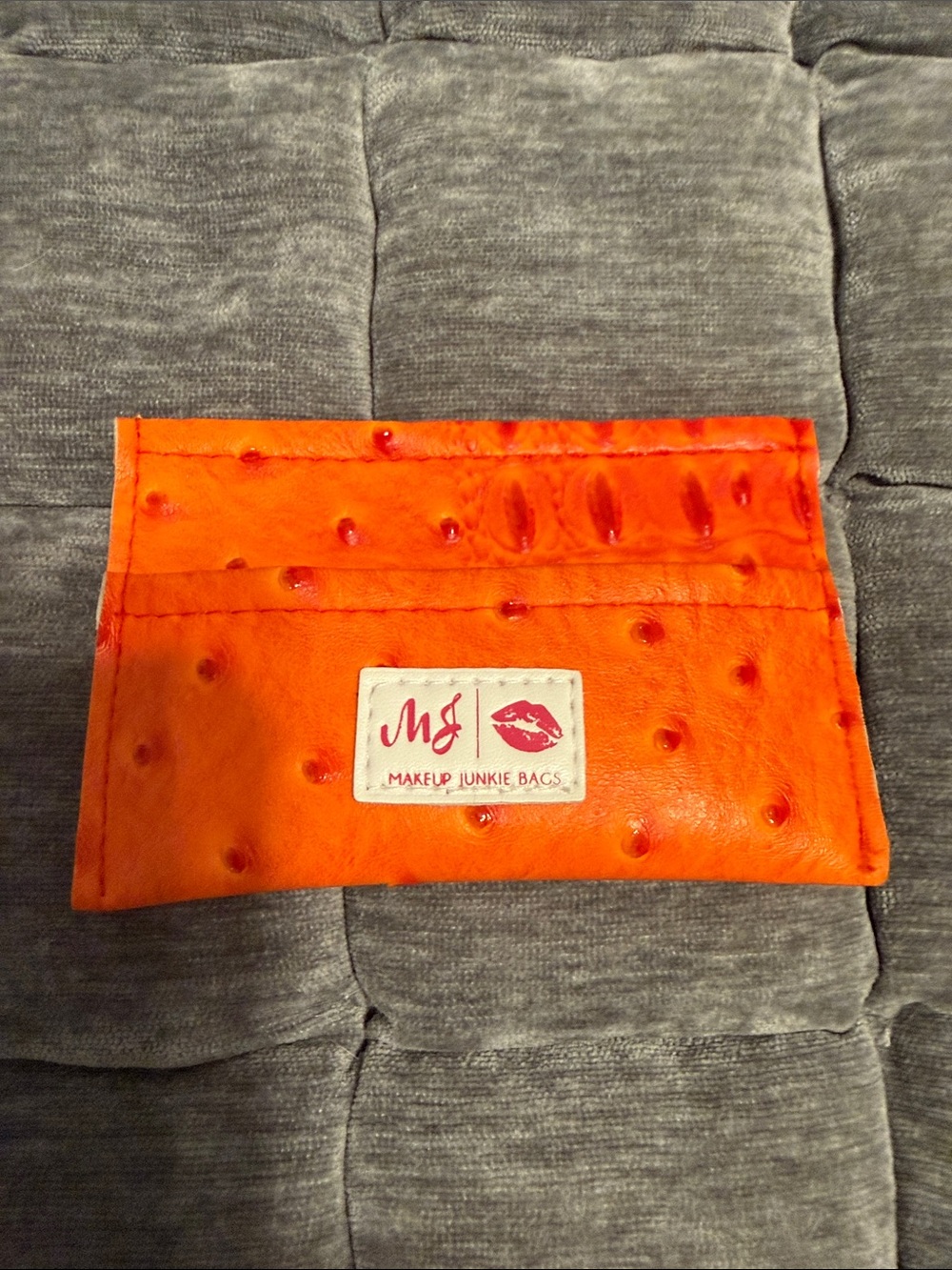 Makeup Junkie orange dune card holder.